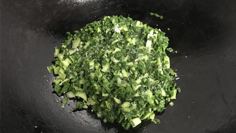 腊肠绣花锦菜饭,7成热,放入切碎的绣花锦翻炒至变软加少许盐炒匀后即可熄火盛出。