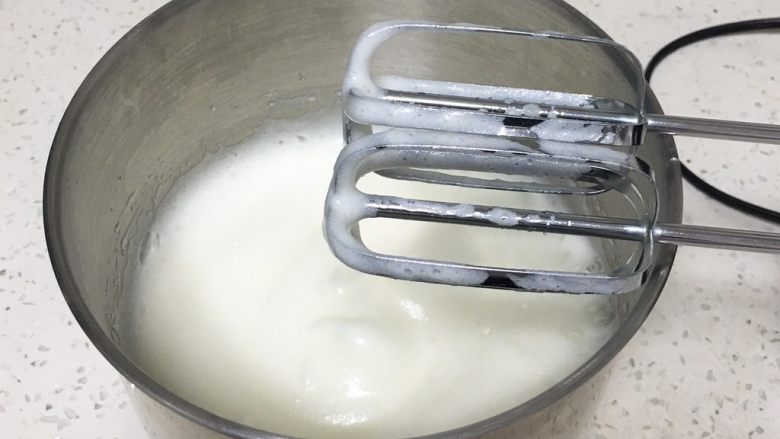 奶油戚风蛋糕,用打蛋器搅打50圈,蛋白出现下垂的弯钩,加入15克细砂糖。