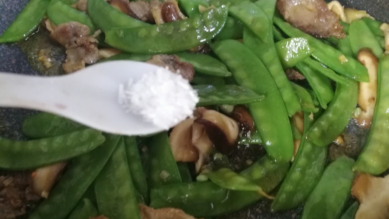 肉炒荷兰豆香菇,煸炒几下后,最后出锅前放入少许的<a style='color:red;display:inline-block;' href='/shicai/ 717'>味精</a>。