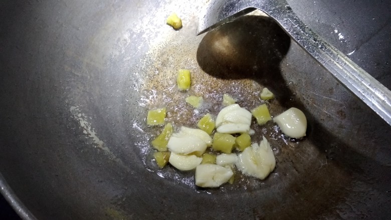 麻辣牛蛙,锅烧热,放入适量色拉油,放入大蒜子和泡椒,煸香。
