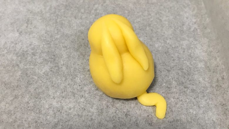 比卡丘烧果子,取少许小面团做出皮卡丘的耳朵和尾巴,粘到身体上。