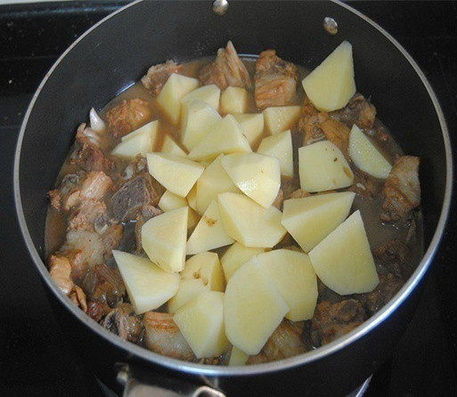 土豆烧肉,开盖子放入土豆翻炒均匀,再盖上盖子焖煮10-15分钟即可;