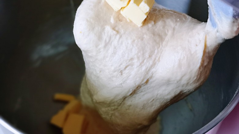 超级松软零失败的全麦蜜豆小餐包,10分钟后加入室温软化的<a style='color:red;display:inline-block;' href='/shicai/ 887'>黄油</a>,再次启动厨师机2档,揉20分钟,揉到不容易破的手套膜,就可以进行发酵了。