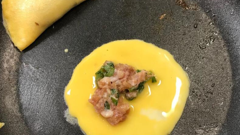 《过年应景-黄金蛋饺》,放上绞肉后,快速将蛋盖起来
➡️记得放上绞肉后,趁蛋液还没熟透让两边定型结合