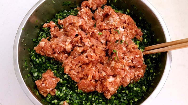 韭菜猪肉馅水饺,把猪肉馅放入韭菜末里,顺着一个方向调匀