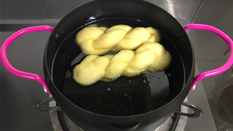 蛋奶麻花,取一锅,倒入适量食用油,油温6、7成热时放入发酵好的麻花。