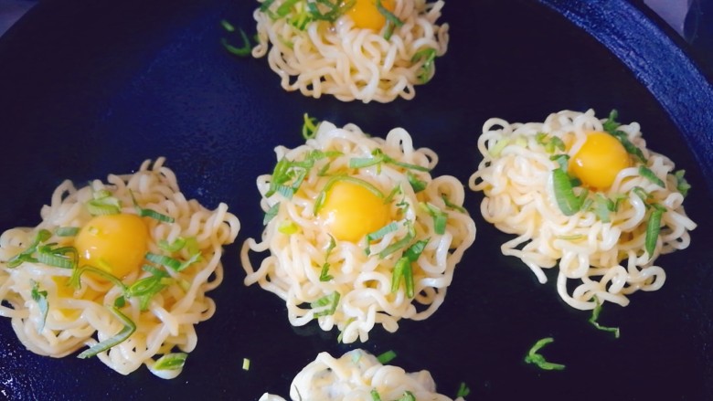 泡面蛋饼(方便面+鹌鹑蛋),撒一层蒜苗沫