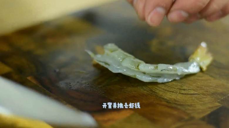 鲜嫩多汁的大虾抱蛋煎饺,你一定得试一下,虾去头留虾尾,开背并挑去虾线,用刀背轻轻敲断虾筋。