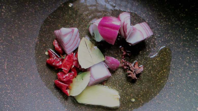 五花肉炖冻豆腐,锅中倒入菜籽油,放入洋葱、葱姜、干辣椒、八角、香叶、花椒爆香,捞出扔掉香料