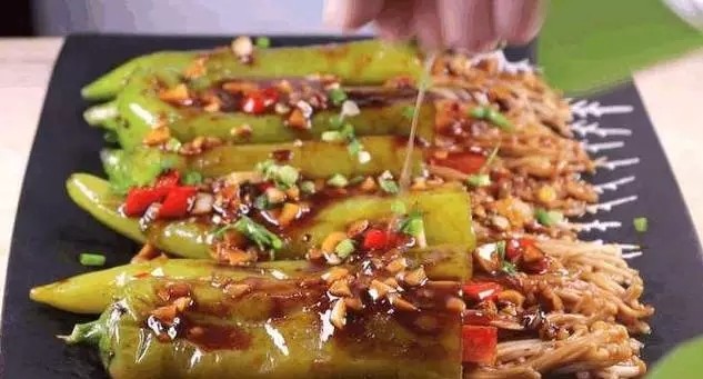 青椒金针菇,将做好的青椒酿金针菇出锅装盘,将锅里浓稠的配料淋在青椒上,撒一些葱花。