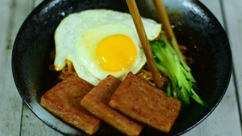 吃了这碗黯然销魂面,你一定会流泪(其实是辣哭的),拌匀摆上煎鸡蛋、午餐肉、黄瓜丝。