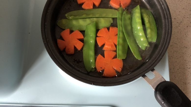 香煎比目鱼,放入荷兰豆和胡萝卜片,煎至断生就可以开动啦!
可撒几颗食盐进行调味。