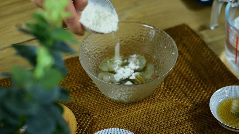 颜色漂亮、造型喜庆,制作又简单的一道家常菜,大虾去掉虾头和虾壳,留虾尾,挑去虾线。加少许盐和淀粉抓匀。