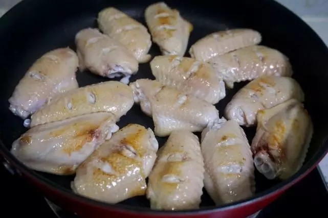 干锅鸡翅,用平底的不粘锅,凉锅放入鸡翅,保持中火,把鸡翅里的油逼出来。大概2-3分钟,就可以翻面,这时候可以转小火,如果放的鸡翅比较多,勤翻动,这样逼出来的油比较多,不放食用油,煎出来的鸡翅照样油亮亮的。