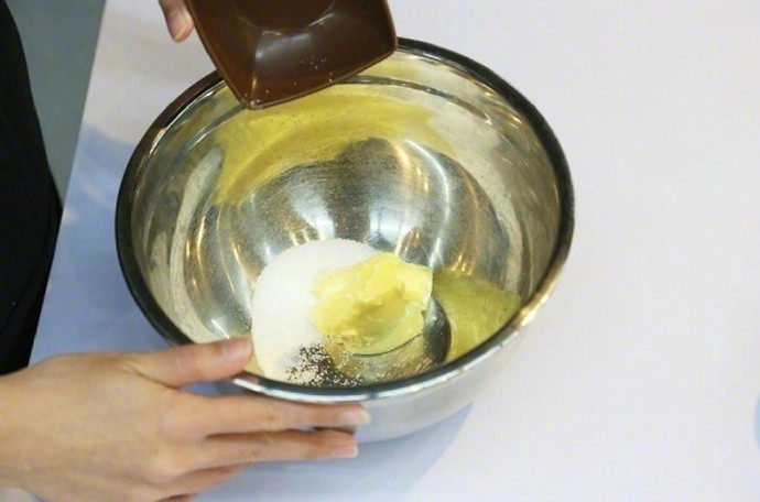 奶香果酱酥饼,将软化的黄油分别加入细砂糖和盐,用打蛋器打发到体积膨松;