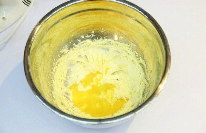 奶香果酱酥饼,分别加入细砂糖和盐,用打蛋器打发到体积膨松。加入全蛋液并搅打均匀;