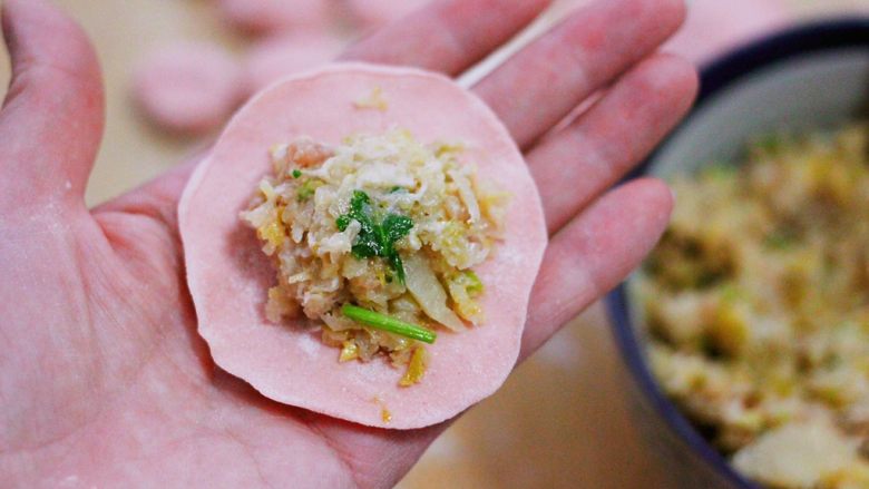酸菜猪肉粉嫩饺子,擀好的面皮上,放入适量的馅料。