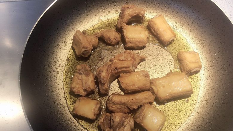 青椒煎排骨,起锅热油,加入排骨,转小火。