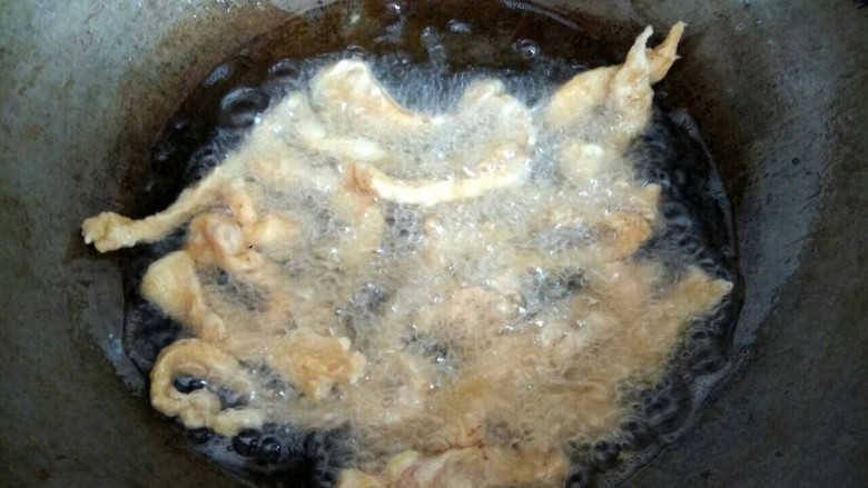 椒盐鸡胸肉,一根一根的放入鸡肉,炸至成形,用筷子翻动,炸至变黄,捞出