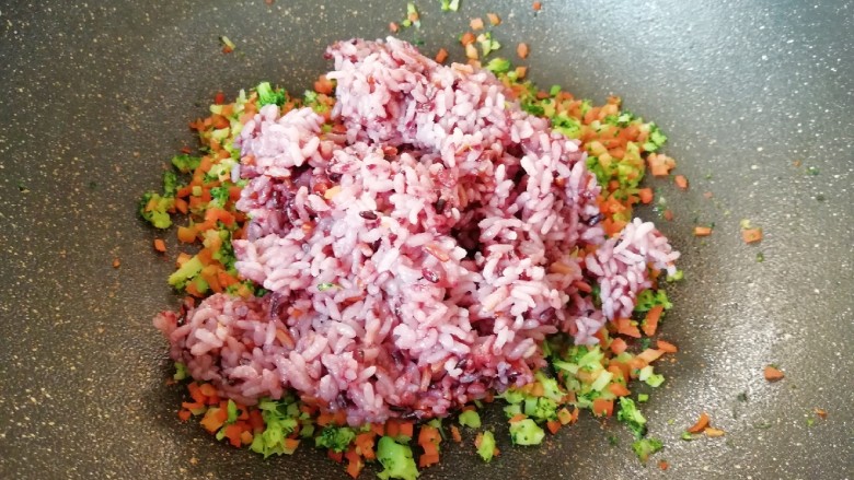 杂粮蔬菜饭团,将杂粮饭倒入炒好的蔬菜里面。