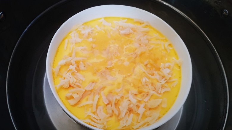 干贝蒸蛋,蒸熟后(用手摇揺碗,即可判断鸡蛋是否蒸熟)打开锅盖,取下盘子。是不是很漂亮呀😄