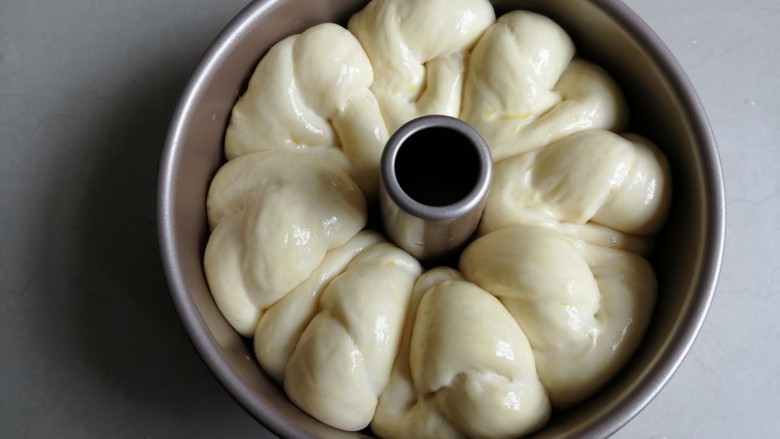炼乳花环面包,放入烤箱(发酵时烤箱内放置一碗热水,使烤箱内有一定的湿度),用烤箱的发酵档37度发酵40分钟左右,在表面刷上蛋液。