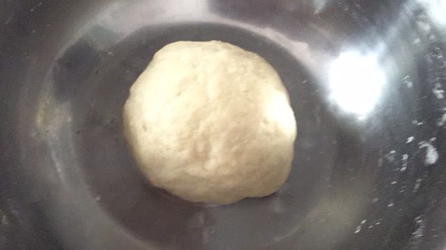 香甜好吃的芝麻糖馅饼,揉面程序结束,取出面团揉成团,盖上保鲜膜,等面团发酵2倍大;