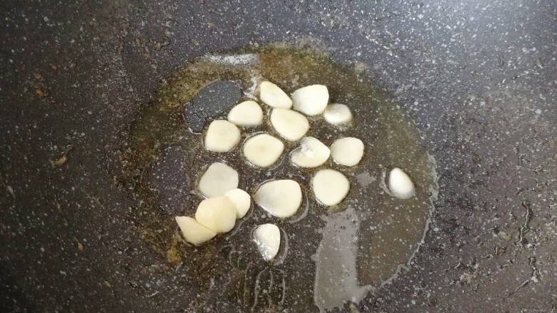 甜豆红萝卜炒虾仁,锅底留余油,下入蒜片炒香。