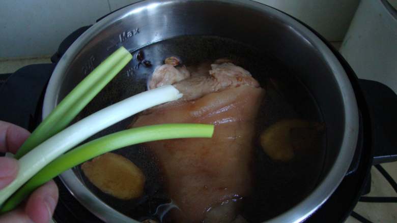 压桌菜:酱汁全肘,放葱段,压制30分钟,焖至自然放气
