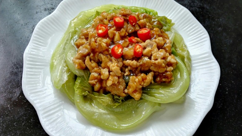 肉末生菜,将炒好的肉末浇在生菜上,放上小米辣点缀