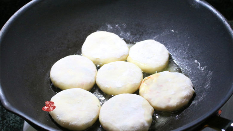 学生营养早餐饼,烧热煎锅，倒入少许食用油，把馅饼整齐铺在锅内，中小火煎至两面焦黄色，馅饼的面皮煎定型后就不会碰烂。