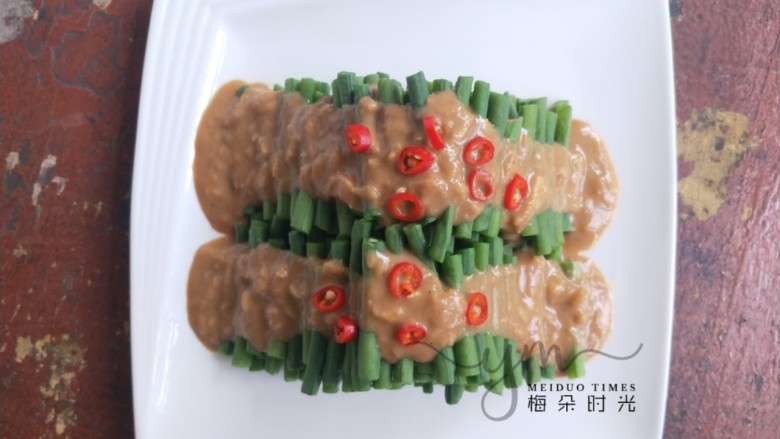 麻汁豆角,然后把调味汁淋上去,切点红辣椒圈装饰。