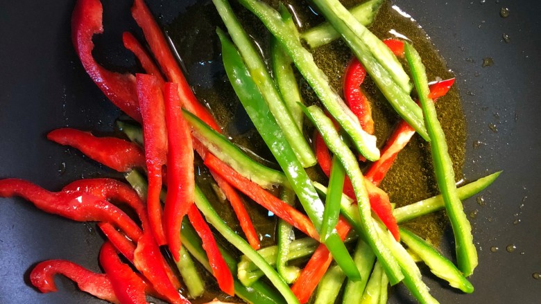 青椒土豆丝,起锅烧油道路，青红辣椒翻炒几下。