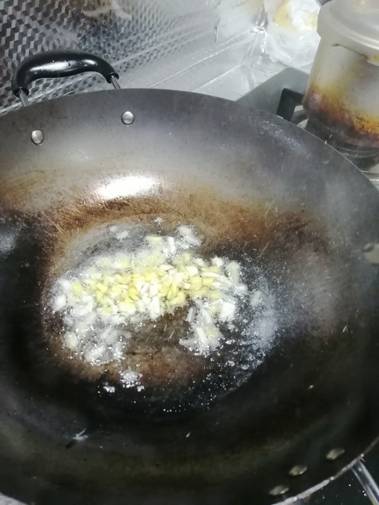 红烧鱼块,开火,加入油,然后加入姜蒜翻炒。