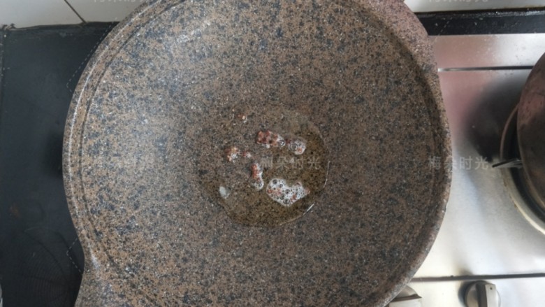 蒜香蒸茄子,炒锅内放油,放十来粒花椒炸一炸,然后把花椒粒捞出扔掉。这时候油温很高了,关火。
