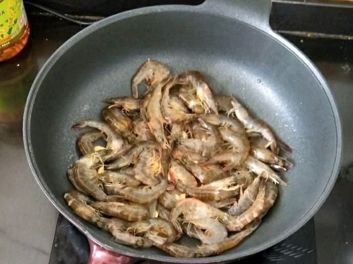 葱香油爆虾,然后倒入处理干净的虾,翻炒均匀。