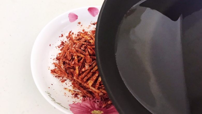 风味酱香乳瓜,把油烧至微微冒烟,就浇到姜蒜丝上面