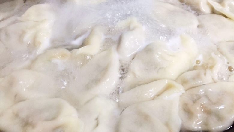 猪肉蒜苗水饺,饺子下锅煮熟(开盖煮皮,刚下锅时要经常顺锅边搅动,以免饺子粘锅底,水开后盖盖煮馅,但是要看住别让饺子汤溢出来)