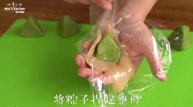 满足夏日贪凉小心思的【抹茶水晶粽】,爽口Q弹,取一份水晶皮置于保鲜膜上,整形成三角形,放上抹茶内馅,包裹捏合整形即可。