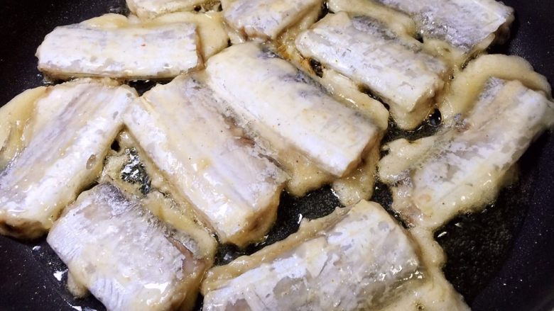 煎带鱼,平底锅放油烧热,放入带鱼煎制