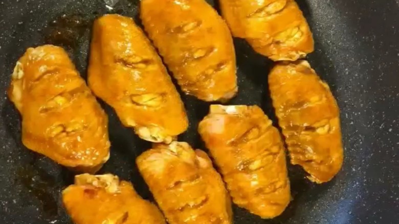 可乐鸡翅,锅中烧油放入鸡翅，小火煎至两面金黄