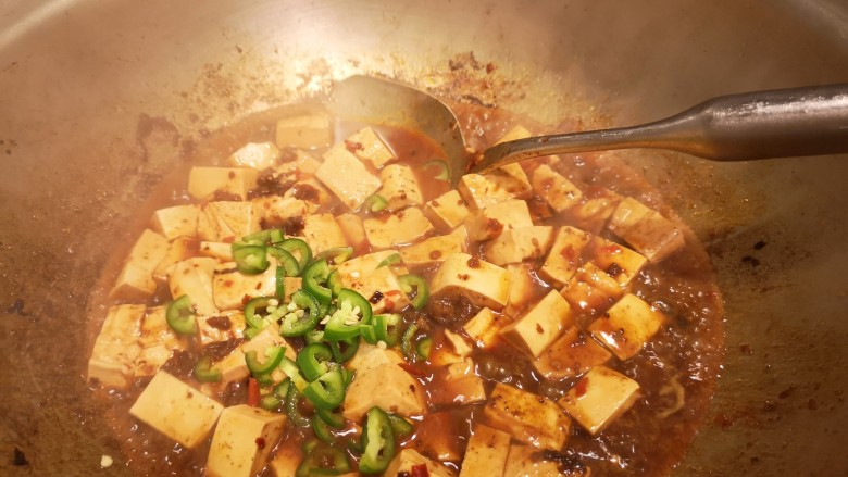 麻婆豆腐,打开锅盖,加入辣椒丁。