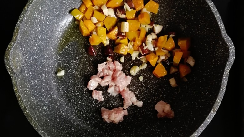 南瓜肉末炒饭,将蔬菜推到一边,倒入腌好的猪肉炒至变色