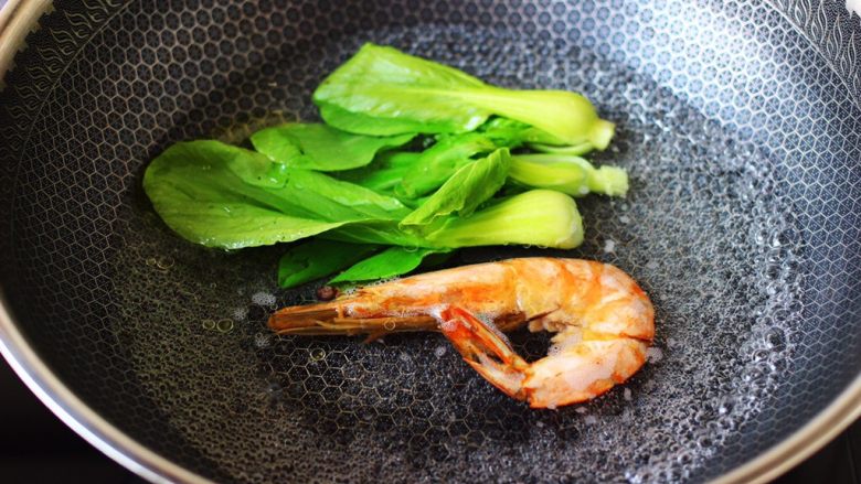 田头菇鸡汤时蔬海鲜米粉,锅中倒入适量的清水,加入少许盐和几滴食用油烧开,先放入对虾煮至变色,再放入<a style='color:red;display:inline-block;' href='/shicai/ 6680'>小油菜</a>焯至断生变色的时候,捞出沥干水分。