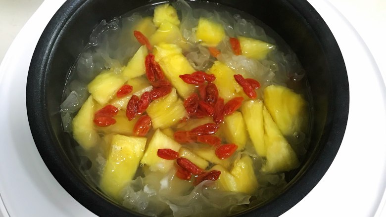 桃胶银耳凤梨甜汤,加入凤梨和枸杞子,时间到了即可食用。