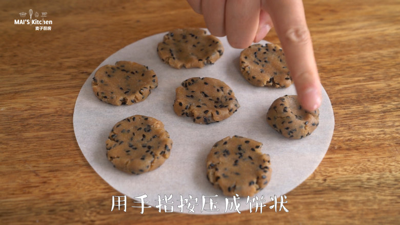 【全麦芝麻酥饼】口感更加香浓,将面团分成10g每个,搓成小圆球,放于烘焙纸上,压成小圆饼。