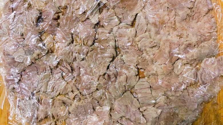 宝宝辅食之牛肉松,用擀面杖敲击辊压,肉质敲至松散。