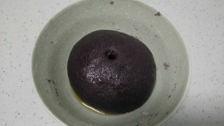 黑米苹果、蜜枣、葡萄干包子,表面均匀涂上食用油,盖上锅盖发酵至2倍大。