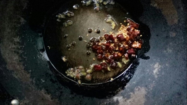 梅干菜鲜肉锅盔,炒锅倒油,小火炒香<a style='color:red;display:inline-block;' href='/shicai/ 62'>辣椒</a>粒、姜粒和花椒。