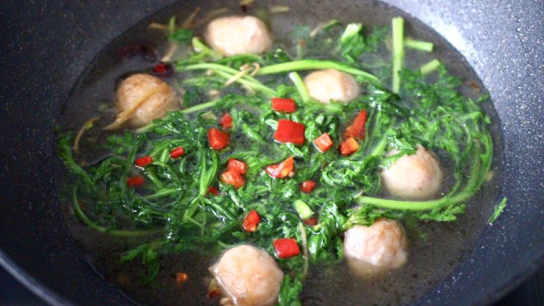 茼蒿墨鱼丸子汤,上面撒上红椒,再煮1分钟即可关火。